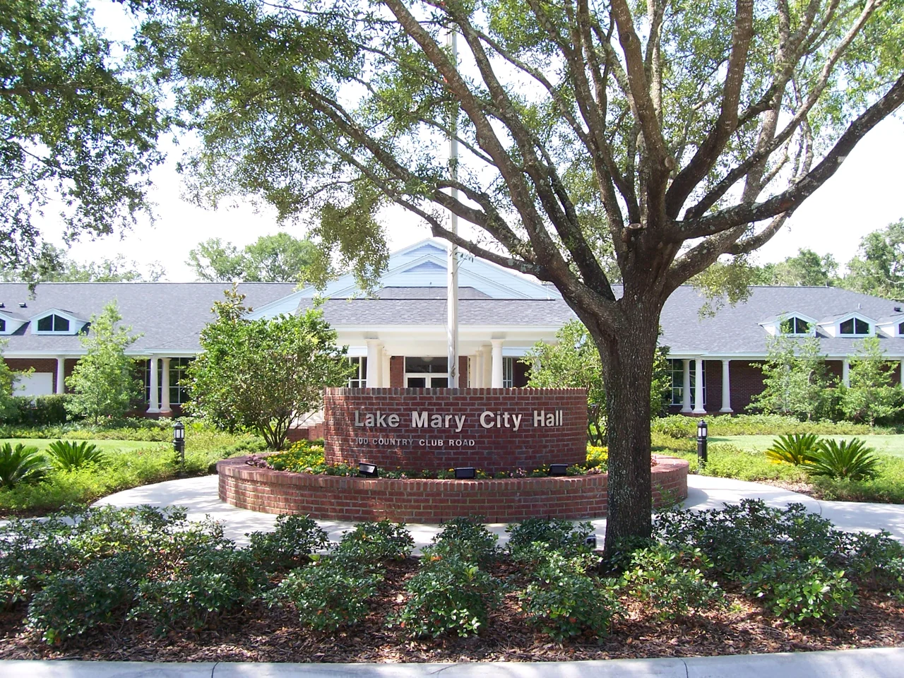 Lake Mary City Hall beneath mature trees in Lake Mary, Florida